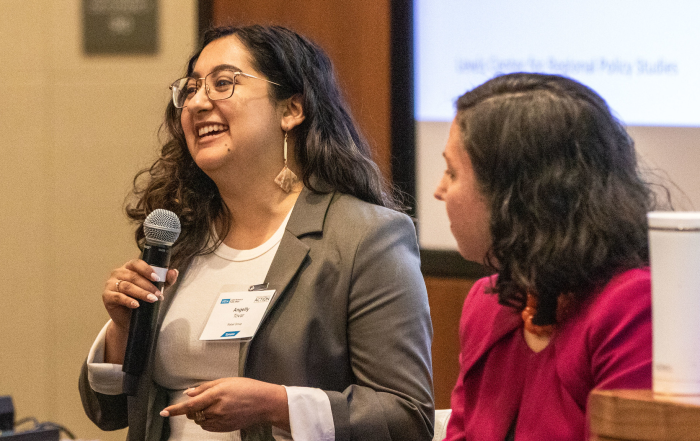 Angelly Tovar (left), holding a microphone, with Avital Shavit seated next to her.